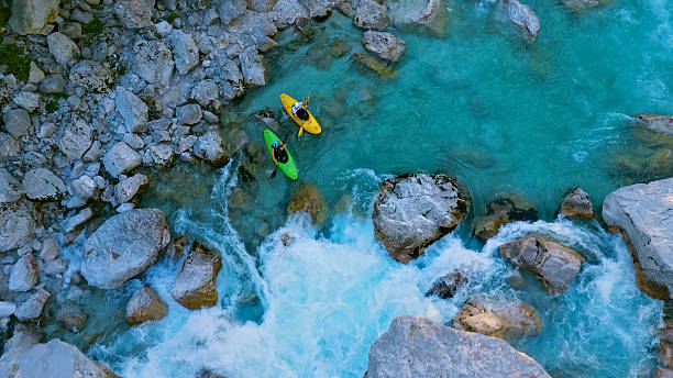 istock Kayakers navigate rapids, conquering the wild river's mighty waves 2222337987