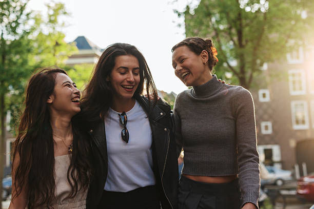 istock Three young women laughing and walking together in Amsterdam 2222338250