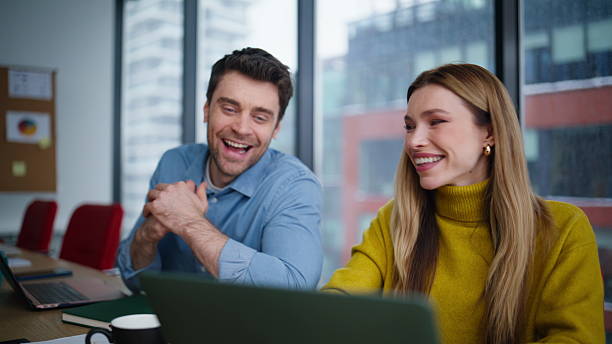 istock Friendly colleagues enjoying teamwork looking laptop at office space closeup. 2222339278
