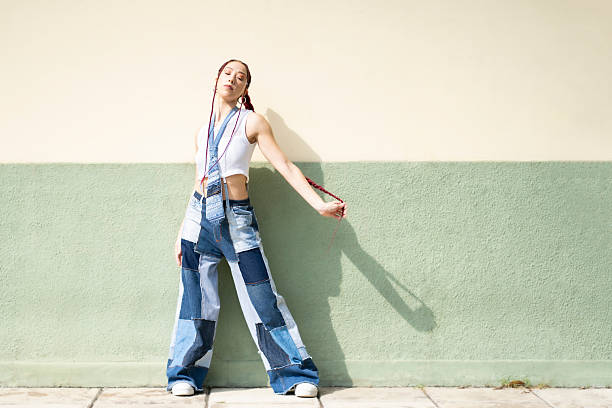 istock Confident woman posing in patchwork jeans and braids 2222339512