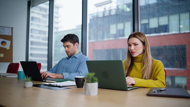 istock Focused managers typing laptops at office window closeup. Woman showing computer 2222339516