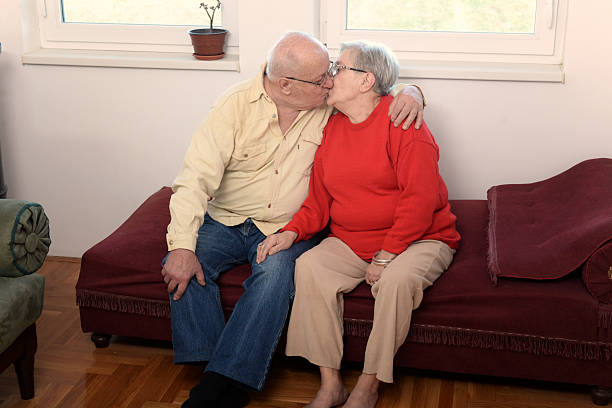 Portrait of a happy elderly couple relaxing together on the sofa at home