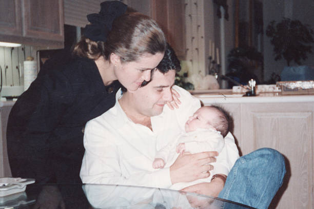 istock Photo taken in 1980s: young parents posing with their baby son 2222346189