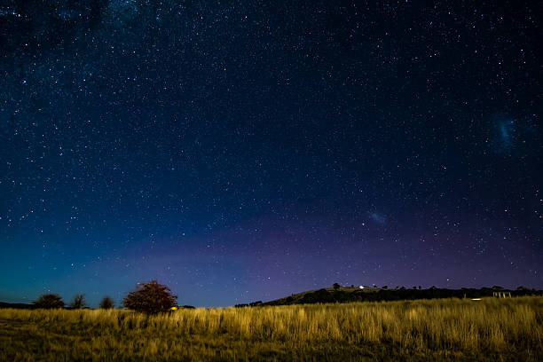 The rural night sky filled with stars as the Aurora Australis begins in Blayney, Central West, NSW, Australia.