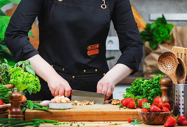 istock Chef expertly chops walnuts s while preparing a vegan meal, surrounded by fresh ingredients in a warm kitchen setting. 2222349379