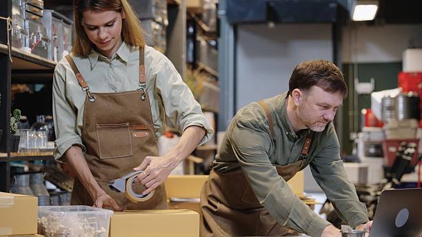 istock Two small business team members checking inventory and  packing new orders online for customer eco friendly brown paper wrapped with environmental Sustainability friendly  before shipping to customers ,zero waster and plastic free  quality control 2222351103