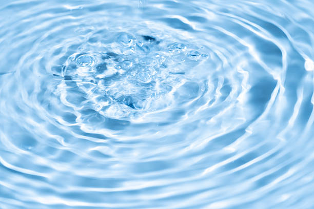 Top view background summer natural Blue surface, clear water with ripples and splashes. water waves in sunlight The water surface has waves and concept background cosmetics moisturizer toner