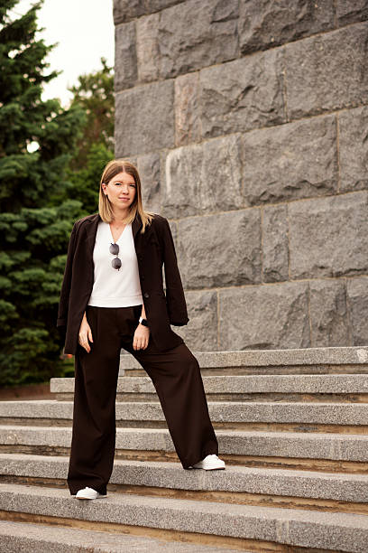 istock Young woman confidently standing on stone staircase, outdoors portrait. 2222359866