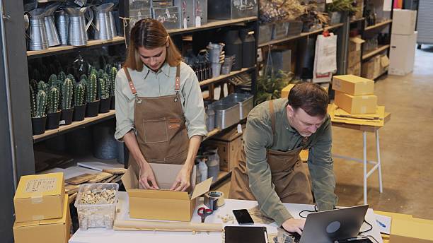 istock Two small business team members checking inventory and  packing new orders online for customer eco friendly brown paper wrapped with environmental Sustainability friendly  before shipping to customers ,zero waster and plastic free  quality control 2222360436