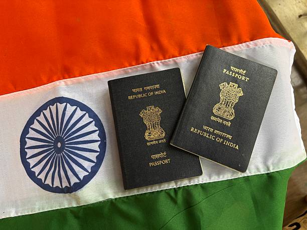 istock indian passport with Indian flag 2222360514