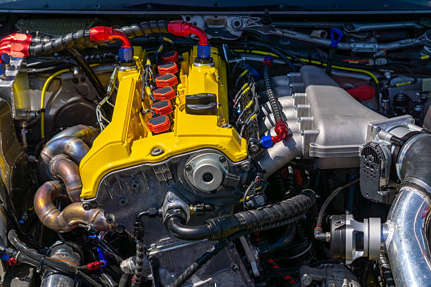 istock modified car engine with a yellow valve cover, colorful wiring, and visible tuning components in a clean engine bay 2222362284