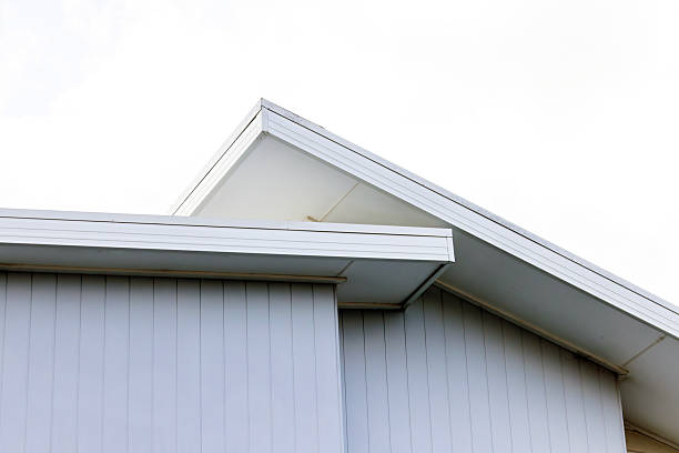 Closeup top part of modern house, white background with copy space, full frame horizontal composition