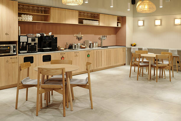 istock Showing Modern Coworking Kitchen Interior with Wooden Tables and Chairs 2222366433