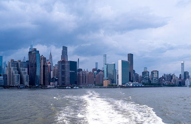 istock Manhattan skyline from departing ferry. Dramatic clouds hover over New York City skyscrapers. 2222366813