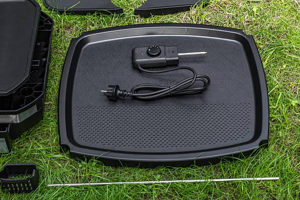 istock Assembling a new grill on the plot, installing an electric grill, hotplate, thermostat, power cable, 2222369653