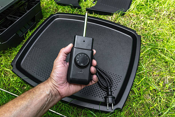 istock Assembling a new grill on the plot, installing an electric grill, hotplate, thermostat, power cable, barbecue 2222369885