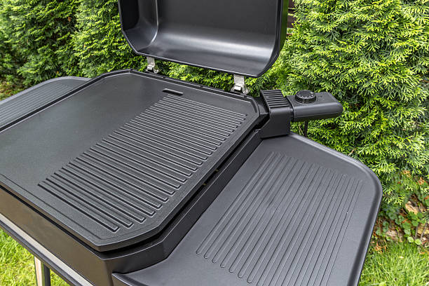 istock Assembling a new grill on the plot, installing an electric grill, hotplate, thermostat, power cable, barbecue 2222370749
