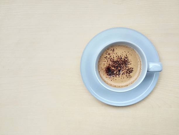 Cappucino coffe in glass on wooden table background, Flat lay. Copy space for text