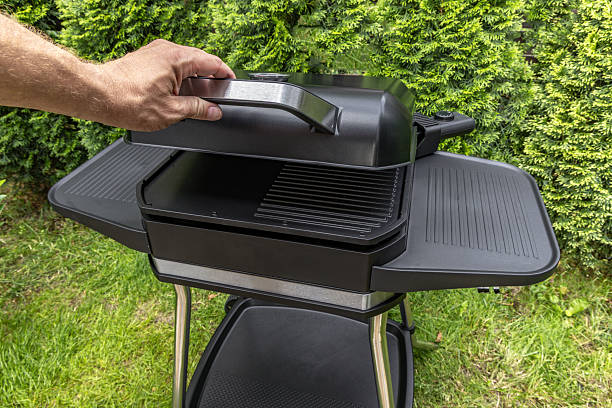 istock Assembling a new grill on the plot, installing an electric grill, hotplate, thermostat, power cable, barbecue 2222370811