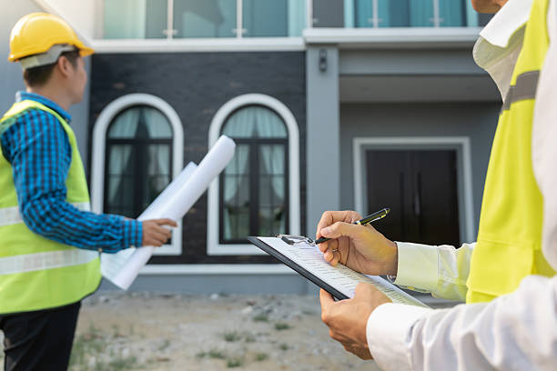istock inspector engineer and owner project is inspecting construction and quality assurance new house. Engineers or architects or contactor work to build the house before handing it over to the homeowner 2222371737