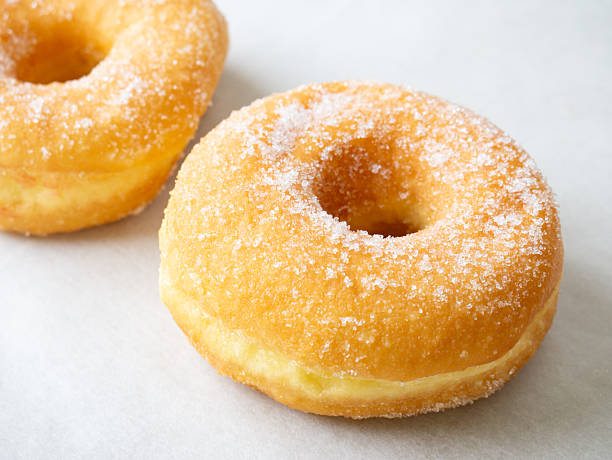 istock Donuts with colorful icing glazed designs on a white background. Copy free space 2222373624