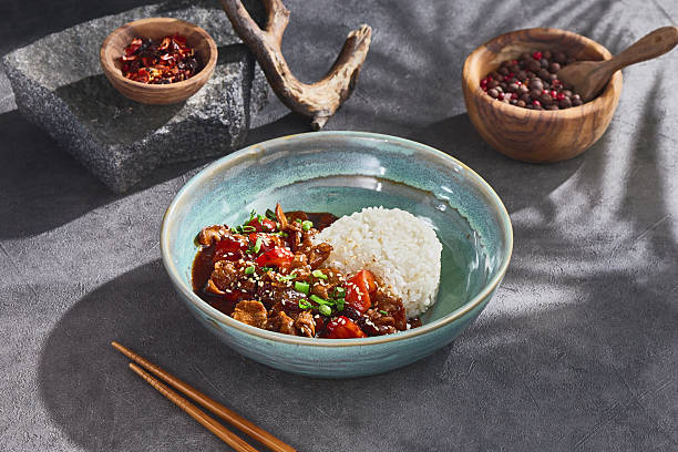istock Pork stir-fry with steamed rice, bright natural lighting, overhead composition 2222376775