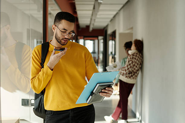 istock Biracial Man Recording Voice Message While Reviewing Documents 2222378228