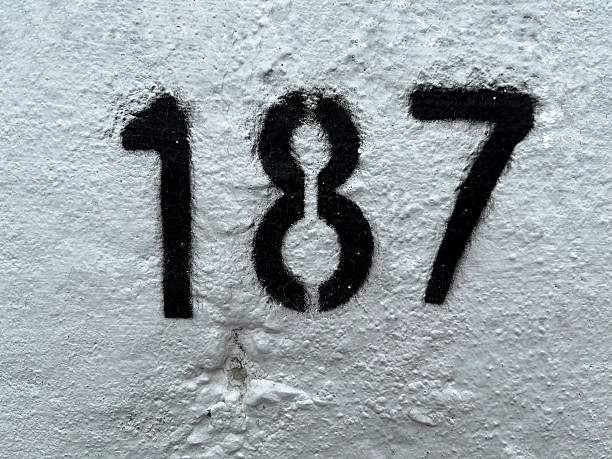 istock Number 187, black, on a white concrete background. 2222378879