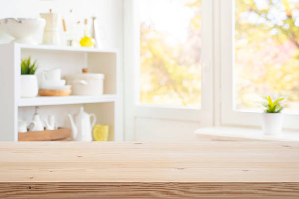 istock Wooden table top for presentation on blurred window and kitchen decoration products background 2222379687