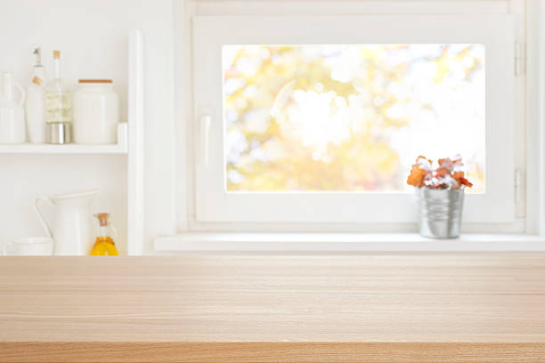 istock Empty wooden table for food presentation on blurred kitchen window background with home decoration products 2222379690