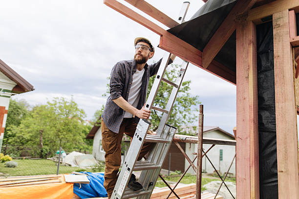istock Skilled Builder Ascends Ladder at Wood Frame Construction Site 2222379711