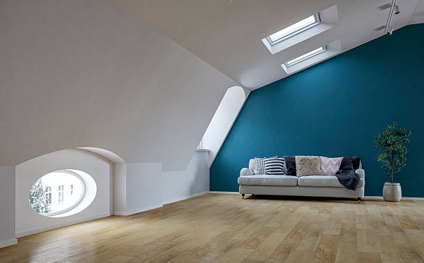 istock Stylish Loft Interior with Blue Accent Wall and Modern Sofa, Skylights on sloped Ceiling 2222383189