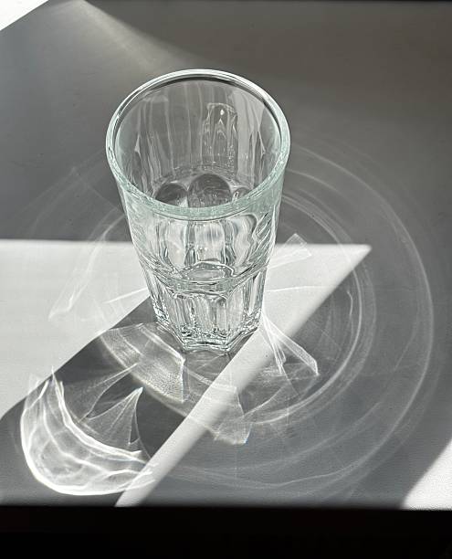 istock Transparent round glass and its shadow, top view 2222384445