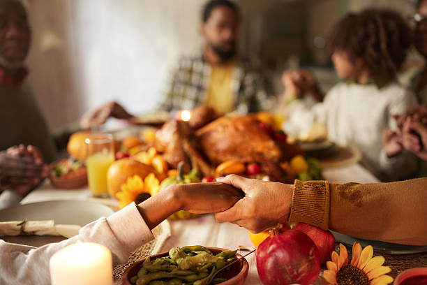 istock Saying grace before Thanksgiving lunch! 2222384611