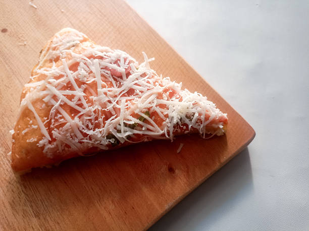 Single slice of pizza on white background