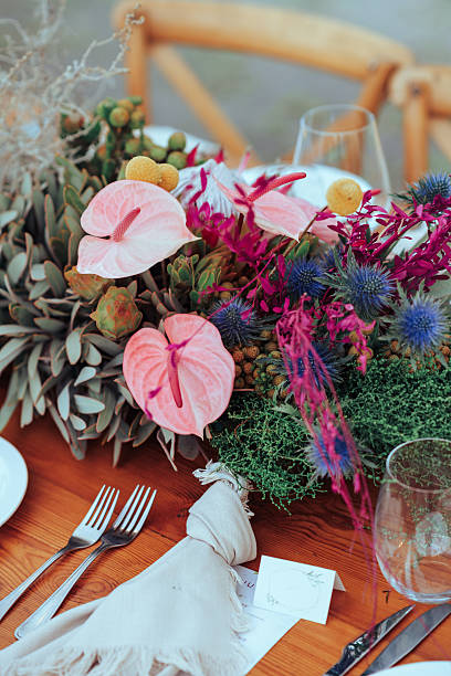 istock Elegant wedding reception table with floral centerpiece and decorative napkins 2222385982