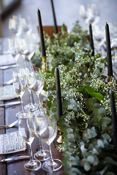 istock Elegant wedding reception table decor with greenery, candles, and glassware 2222386389