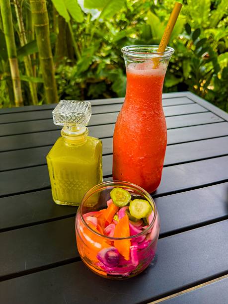 Refreshing Drinks and Pickled Vegetables on Outdoor Table in Lush Setting