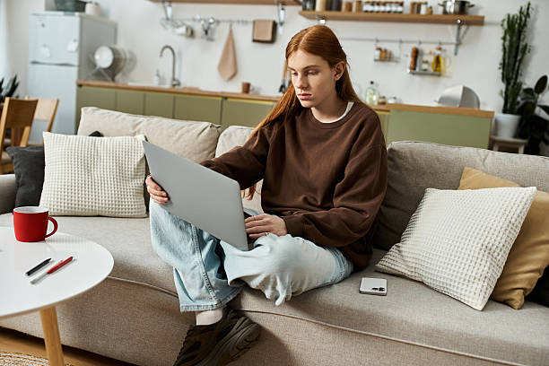 istock Redhead young man immersed in creative work at home in stylish apartment 2222386700