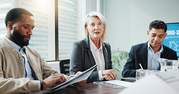 istock People, talking and meeting with document in office for planning, neuroscience and innovation ideas. Manager, presentation and briefing with paperwork, brain technology and proposal for neurofeedback 2222388105