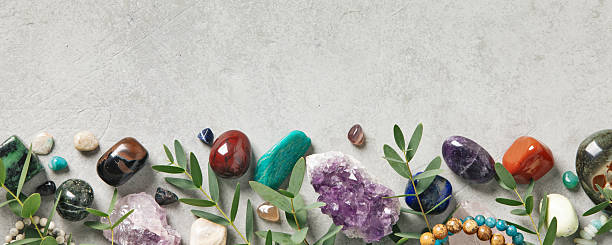 istock Border of Healing Crystals and Greenery on Concrete Surface 2222388255