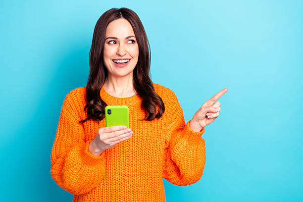 istock Portrait of pretty positive lady look interested direct finger empty space wear pullover isolated on blue color background 2222389603
