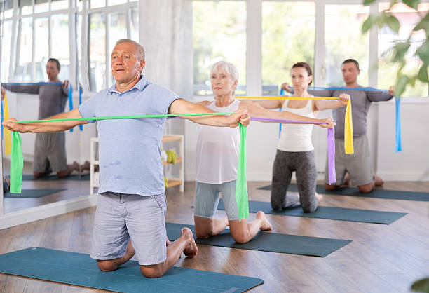 istock Elderly man exercises with pilates band 2222389766