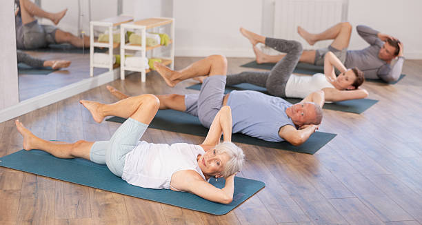 istock Elderly woman doing pilates in group 2222389777