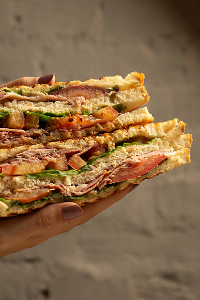 istock Club sandwich with salad, ham, cheese and tomato 2222390255