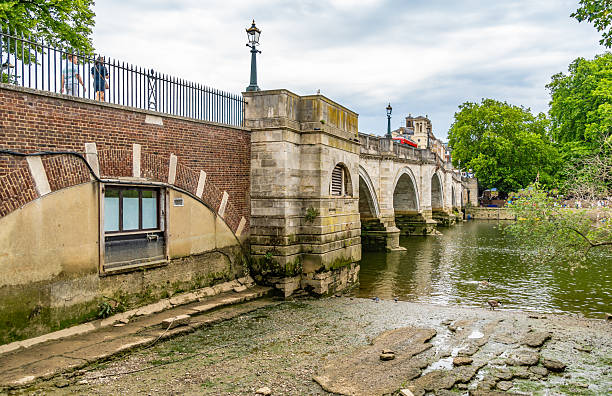 Henley-On-Thames, United Kingdom - July 10, 2015: View across the River Thames towards The Angel Pub with people enjoying the sunshine, Henley-on-Thames, Oxfordshire, England, UK, Western Europe.