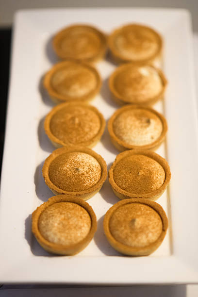 A closeup of butter tarts on a white plate