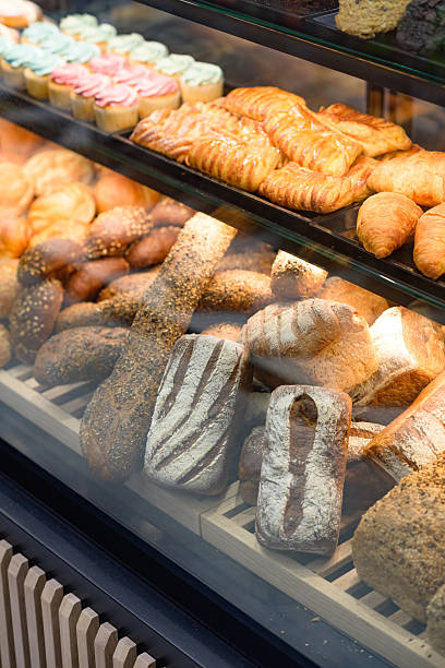 istock Assortment of fresh breads and pastries displayed in a bakery counter 2222391122