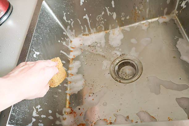 istock Cleaning Process of a Dirty Kitchen Sink 2222391298