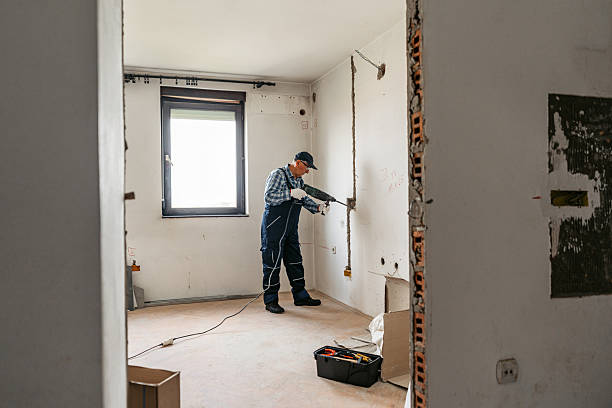 istock Senior Male Worker Drilling The Wall In An Empty Apartment Under Renovation 2222391487